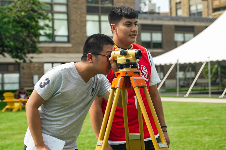 students on the quad surveying